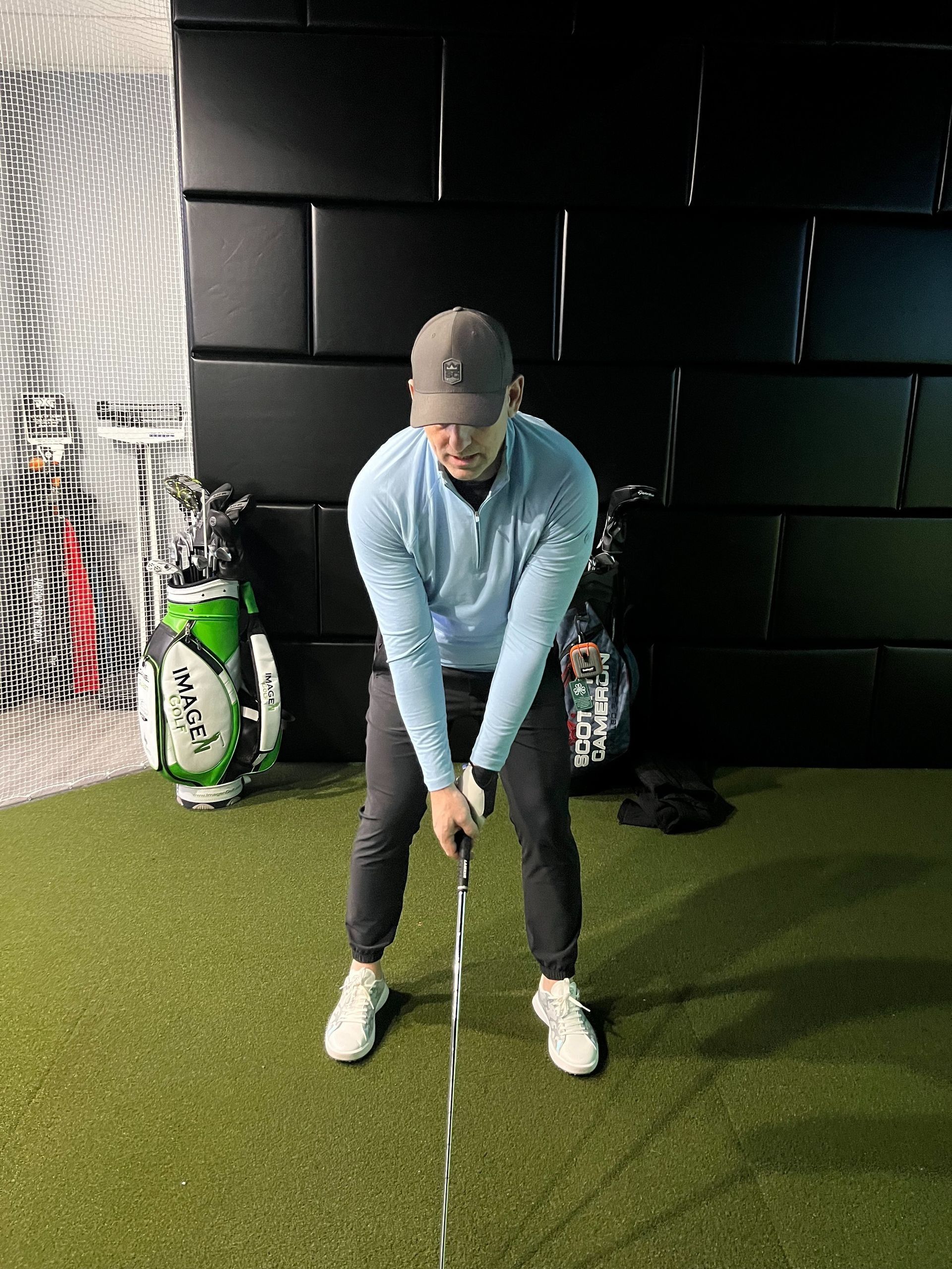 Daniel Guest, Imagen Golf coach, at address in the indoor studio
